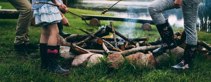 family camping near body of water during daytime